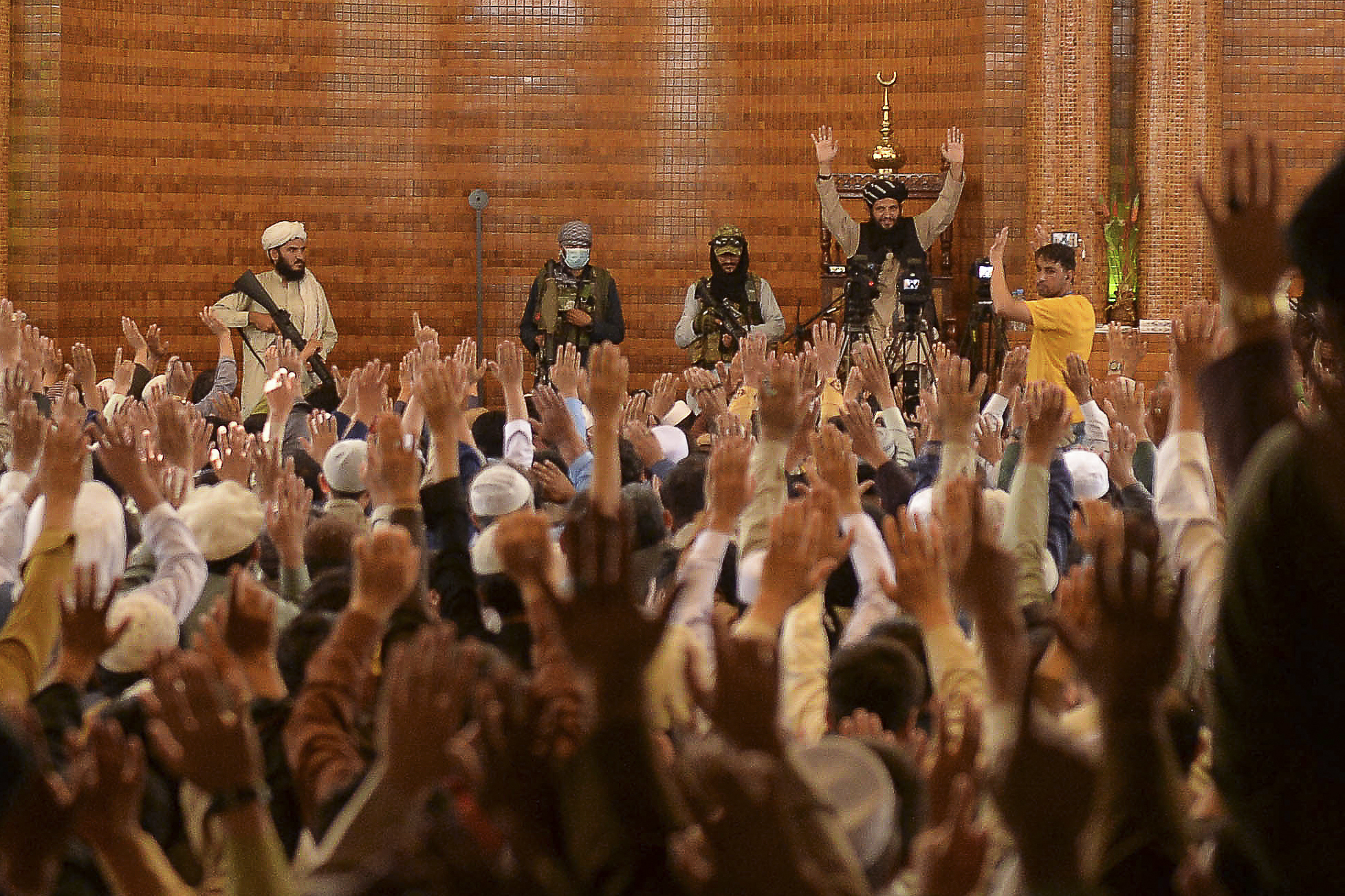 Armed Taliban fighters stand next an Imam during Friday prayers at the Abdul Rahman Mosque in Kabul on August 20, 2021, following the Taliban's stunning takeover of Afghanistan. Photo: Hoshang Hashimi/AFP via Getty Images