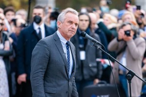 Robert. F. Kennedy Jr. stands in front of a microp