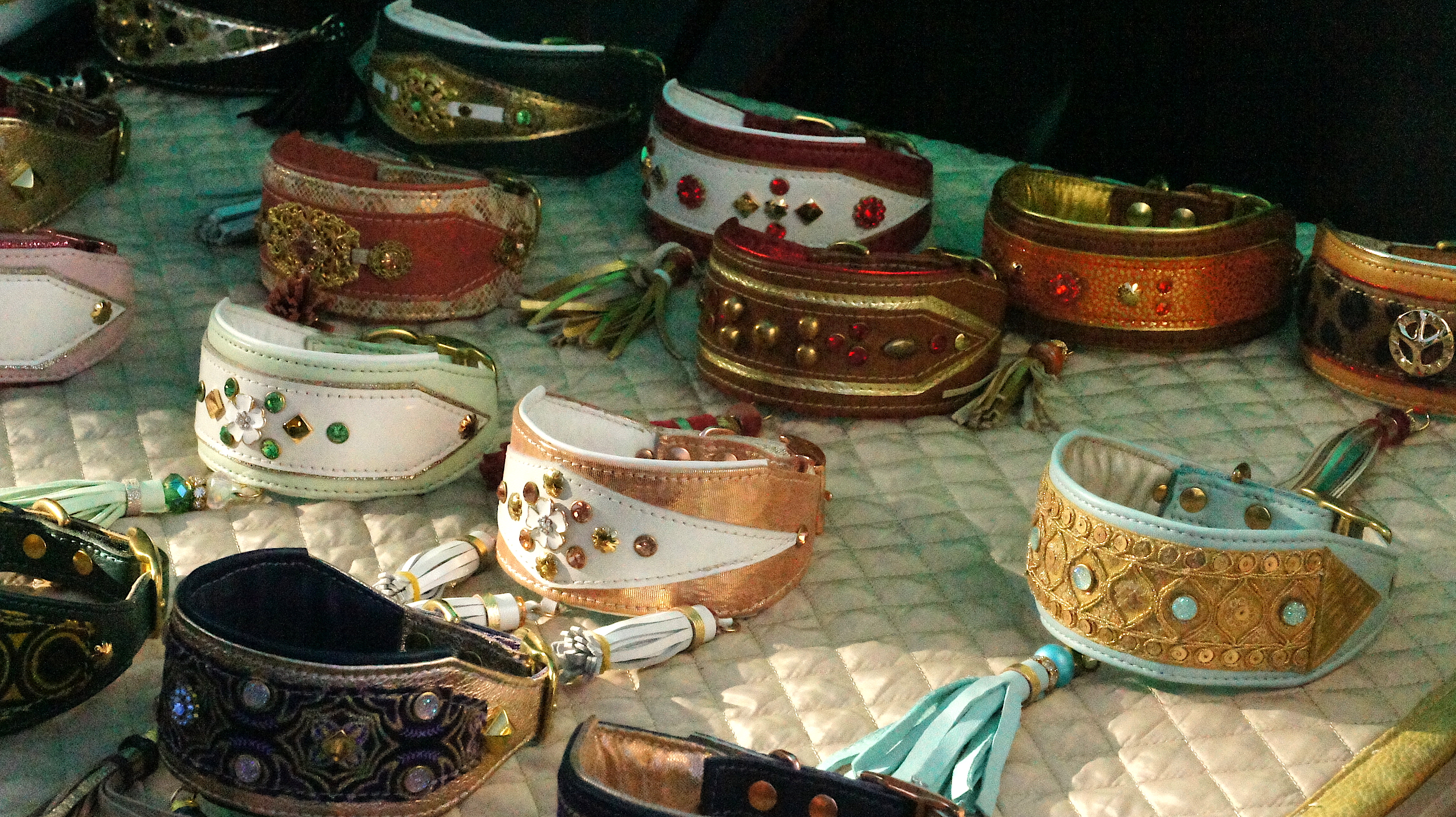 Afghan hound show – table covered in sparkly collars complete with elaborate designs and gemstones in a variety of shades.