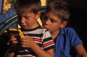 Two boys playing with theGame Boy Color.