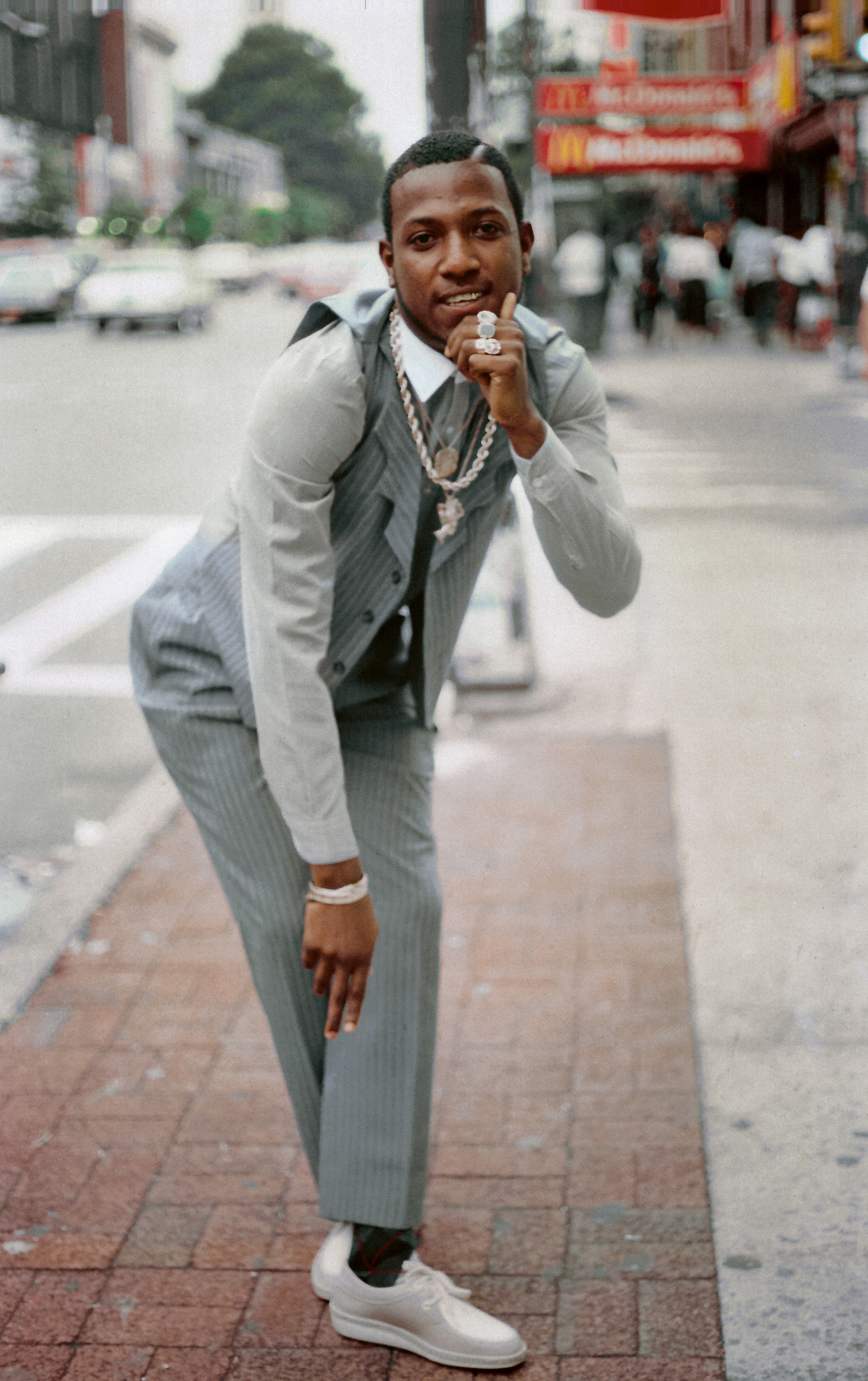 “Rude Boy” Jewelry stylings out of Brooklyn, here East Flatbush specifically, were highly influential and renowned for their uniqueness with flavors of Caribbean style and flair. Single gold cap front, Nefertiti pendant, gold rope chain, and multiple gold rings were a definitive look. Jamel Shabazz, East Flatbush, Brooklyn, New York, 1982