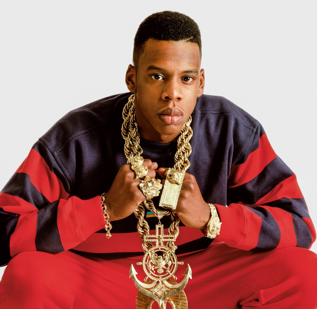 An 18-year-old Jay-Z with a double gold rope with an anchor pendant, tiger nugger watch, king cobra pendant, tiger fourfinger rings and Gucci link bracelet.