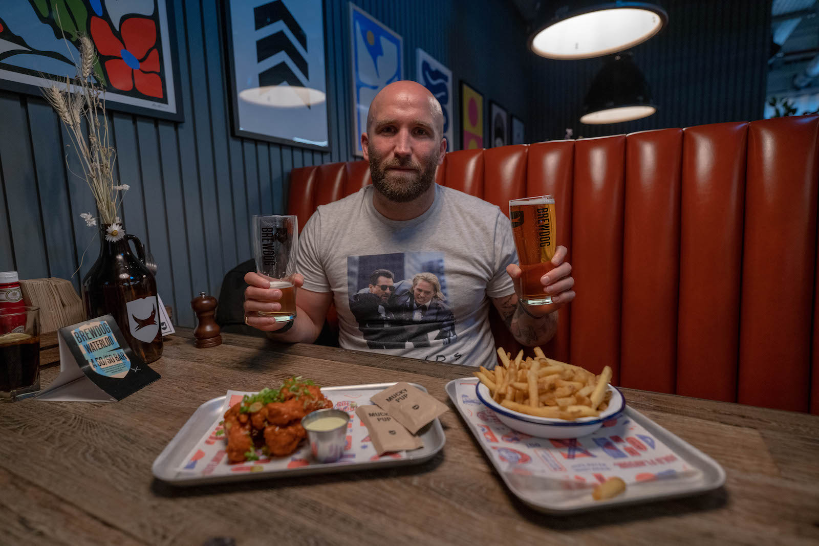 Writer Tom Usher holding some beers in the giant Brewdog