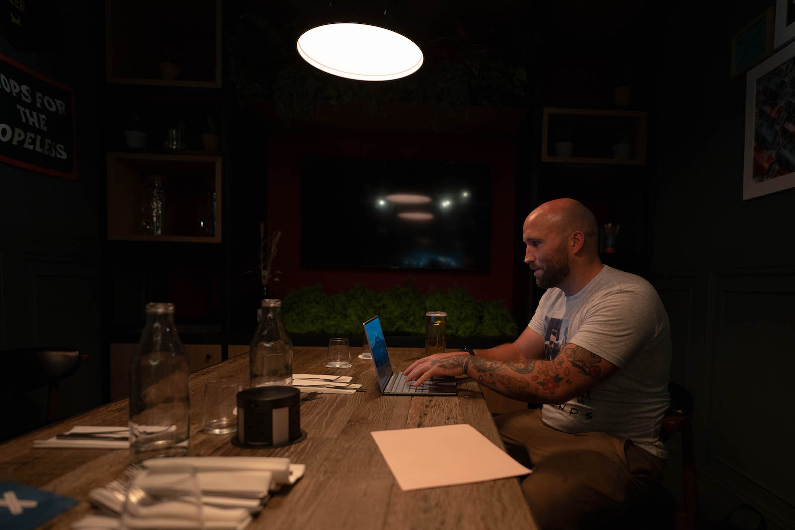 Writer Tom Usher at his laptop in the giant Brewdog