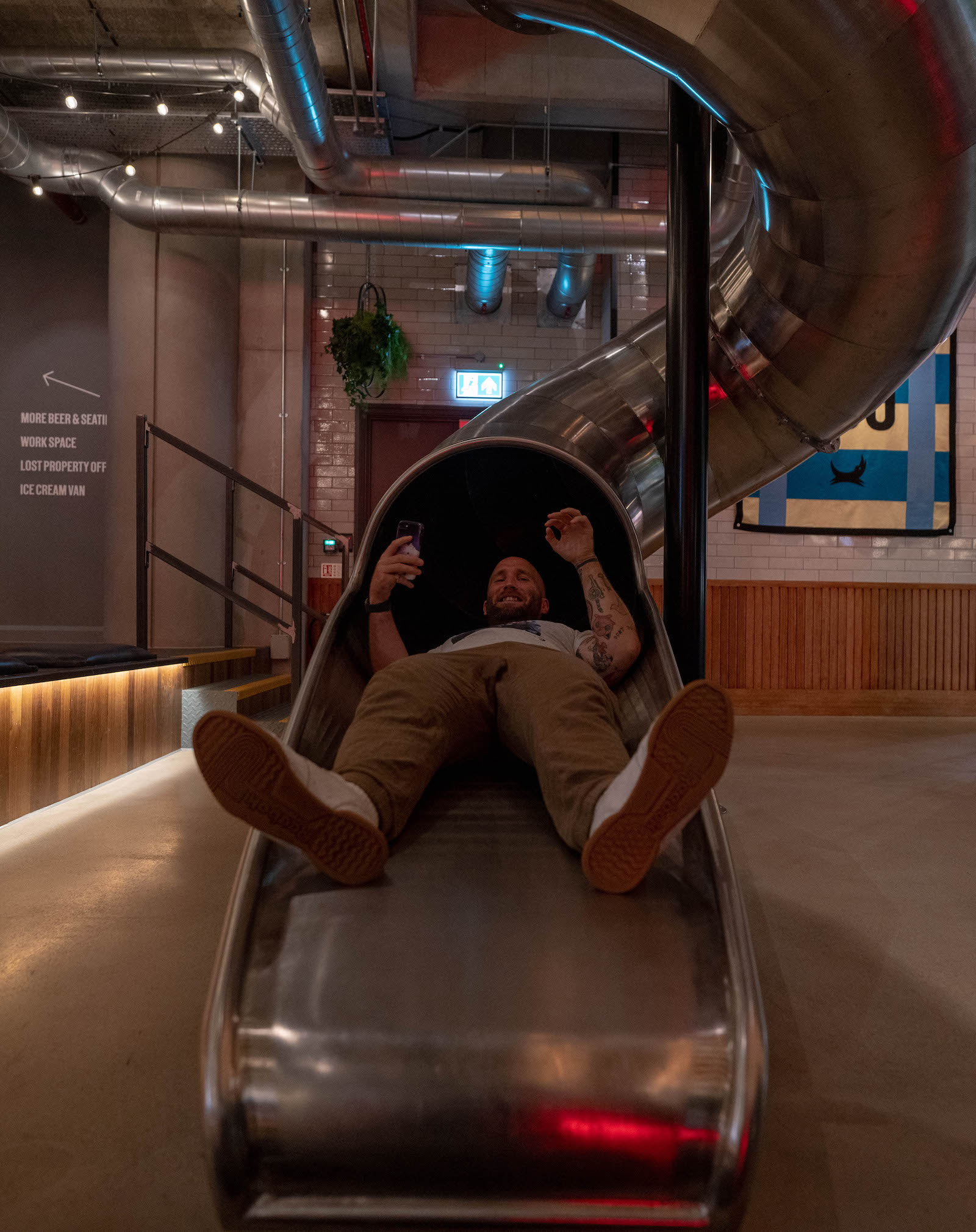 Writer Tom Usher going down the giant slide in the giant Brewdog