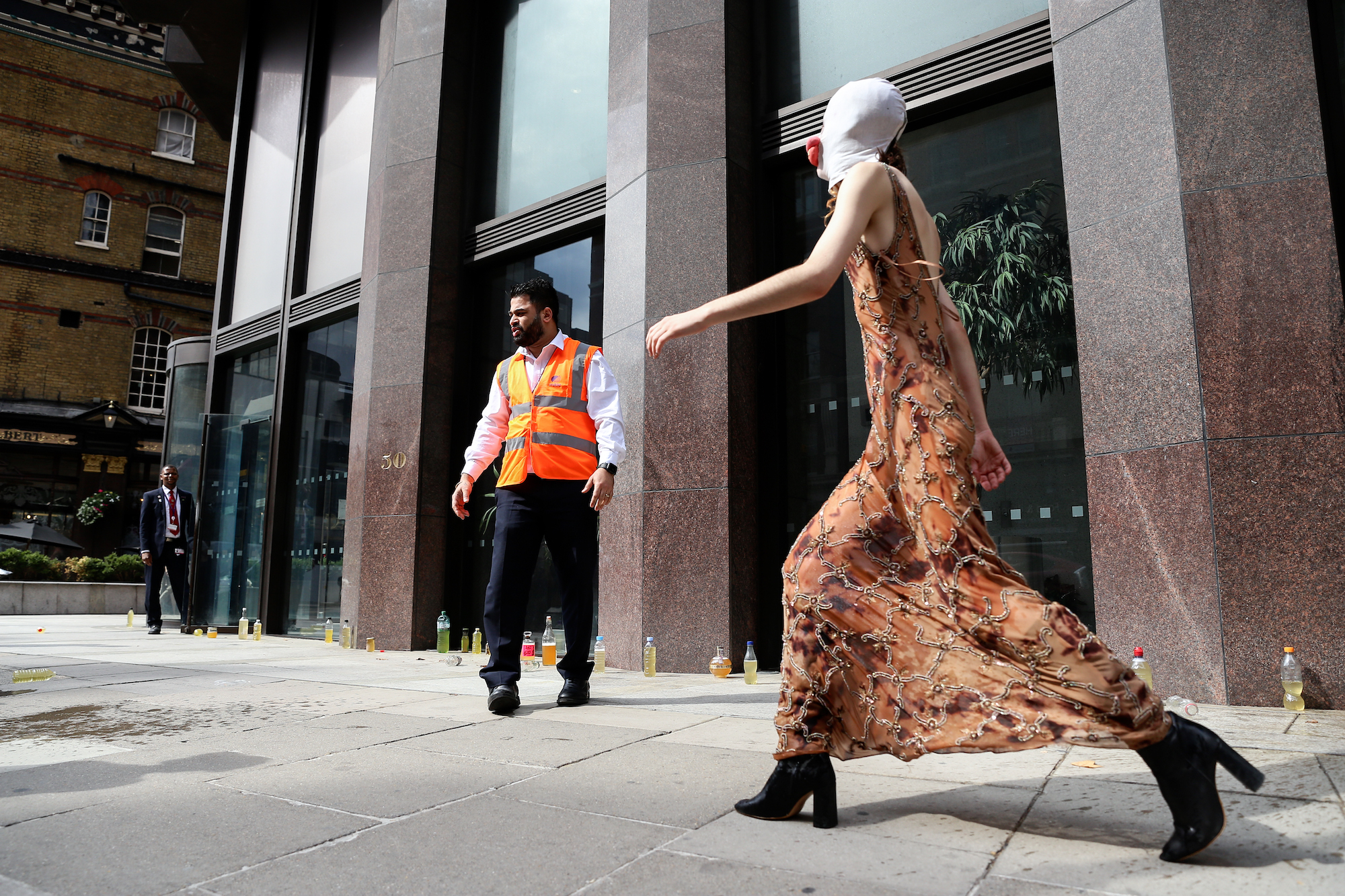 A POT activist walks past the bottles of piss.