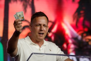 Peter Thiel waving money standing at a lectern, wearing a white shirt