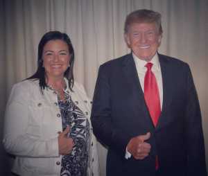 Former President Donald Trump appears with election denier Toni Shuppe.