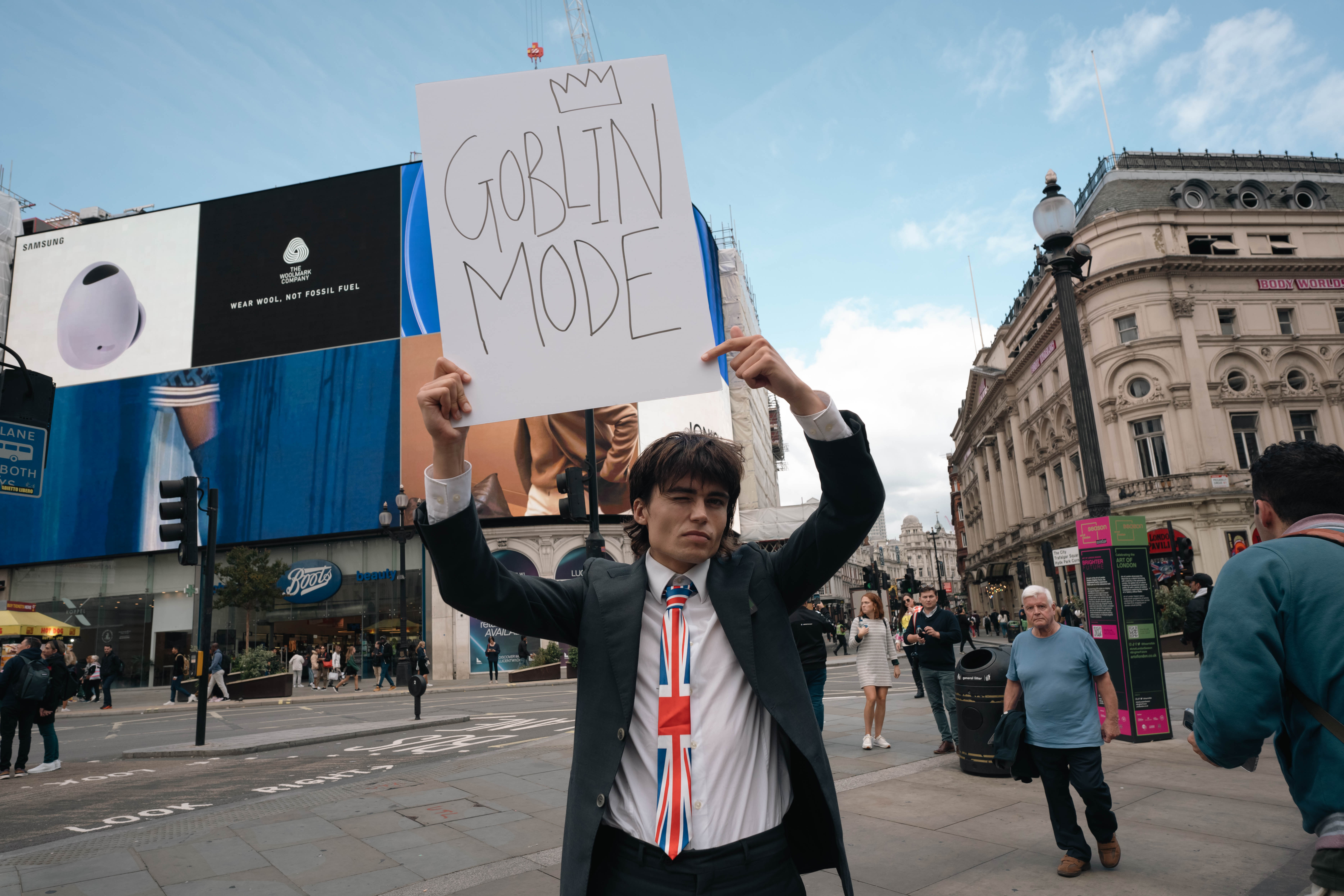 The author holding up a sign reading