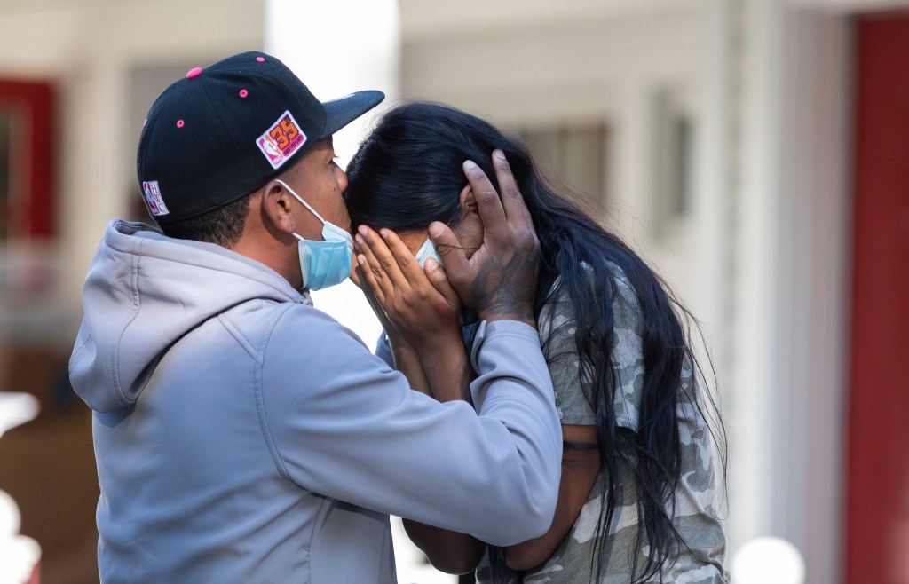 Rafael Eduardo (left) an undocumented immigrant from Venezuela hugs another immigrant outside of the Saint Andrews Episcopal Church, on Marthas Vineyard. Photo by Dominic Chavez