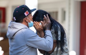 Rafael Eduardo (left) an undocumented immigrant from Venezuela hugs another immigrant outside of the Saint Andrews Episcopal Church, on Marthas Vineyard. Photo by Dominic Chavez