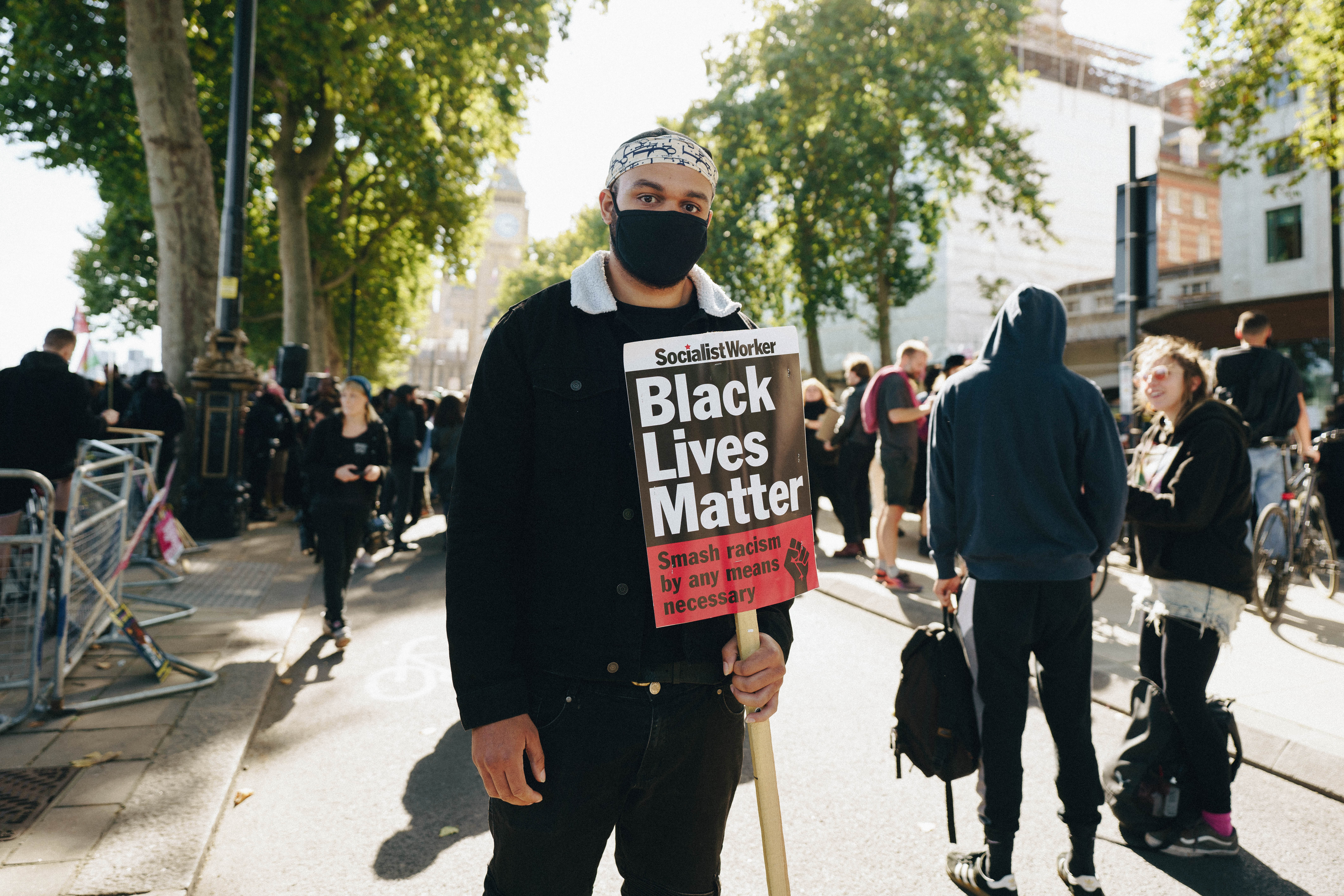 Young man holding BLM sign at the Chris Kaba demonstration