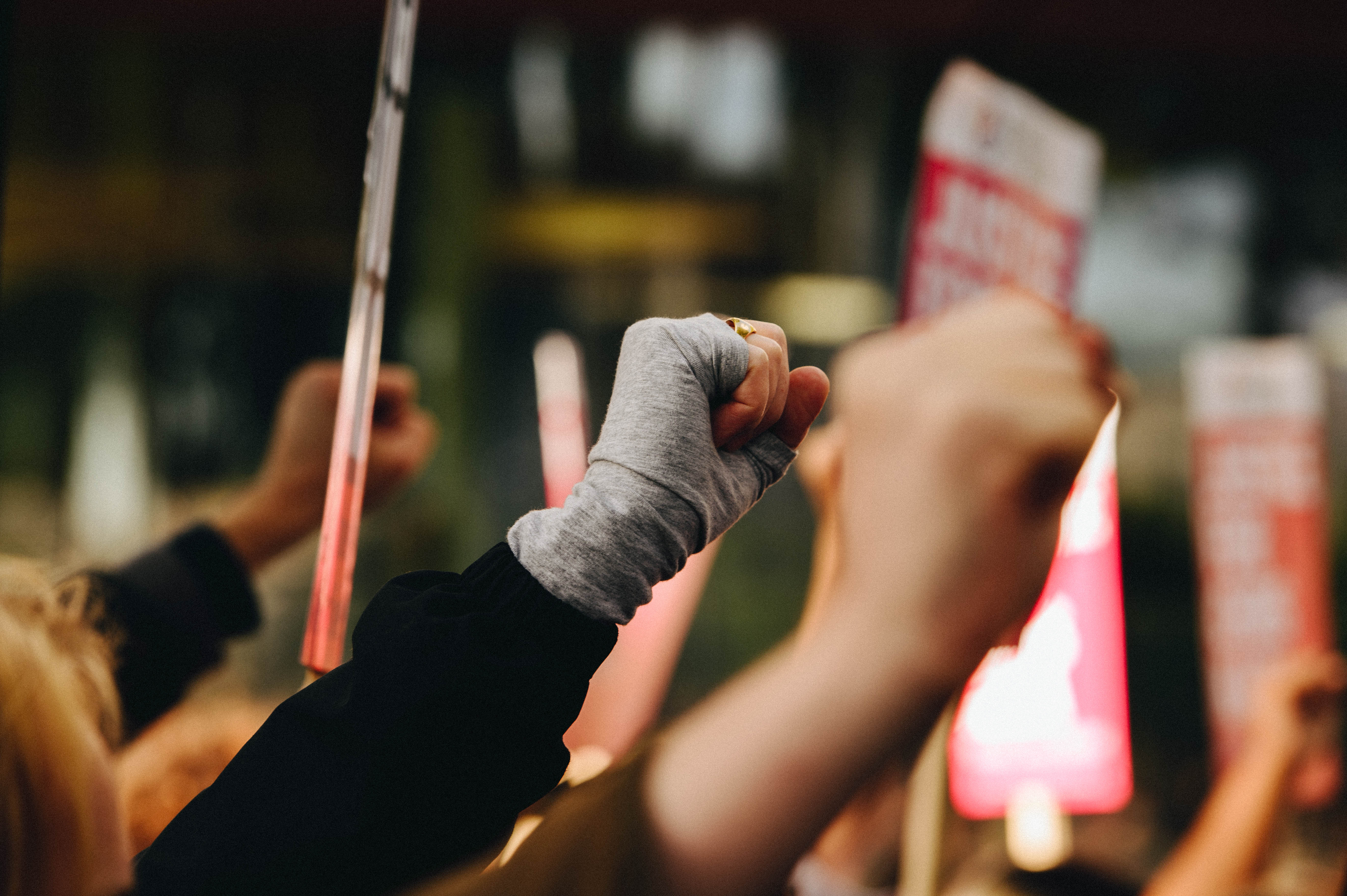 People raise their fists at the Chris Kaba protest.