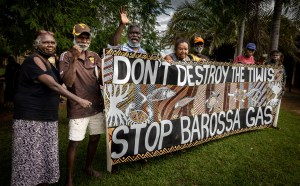 Tiwi Islanders holding the banner they made to protest Santos' Barossa Gas Project