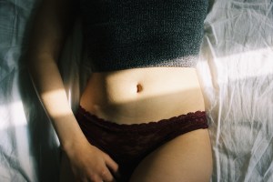 belly button of woman on a bed