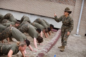 Drill Instructor SSgt. Jennifer Garza of Kerrville, Texas disciplines her Marine recruits with some unscheduled physical training in the sand pit outside their barracks during boot camp February 27, 2013 at MCRD Parris Island, South Carolina.