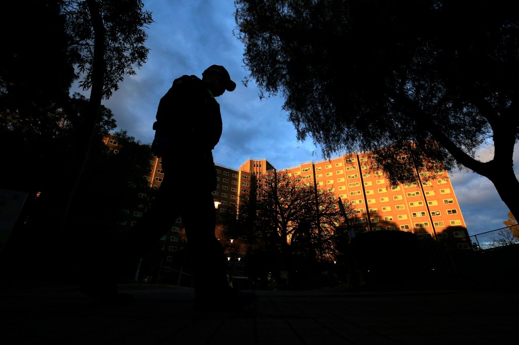 A person stands outside public housing