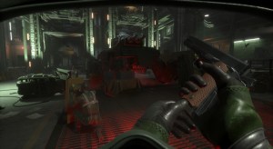 A player reloads their handgun in a large military base, while another player crouches with a shield in front of them.