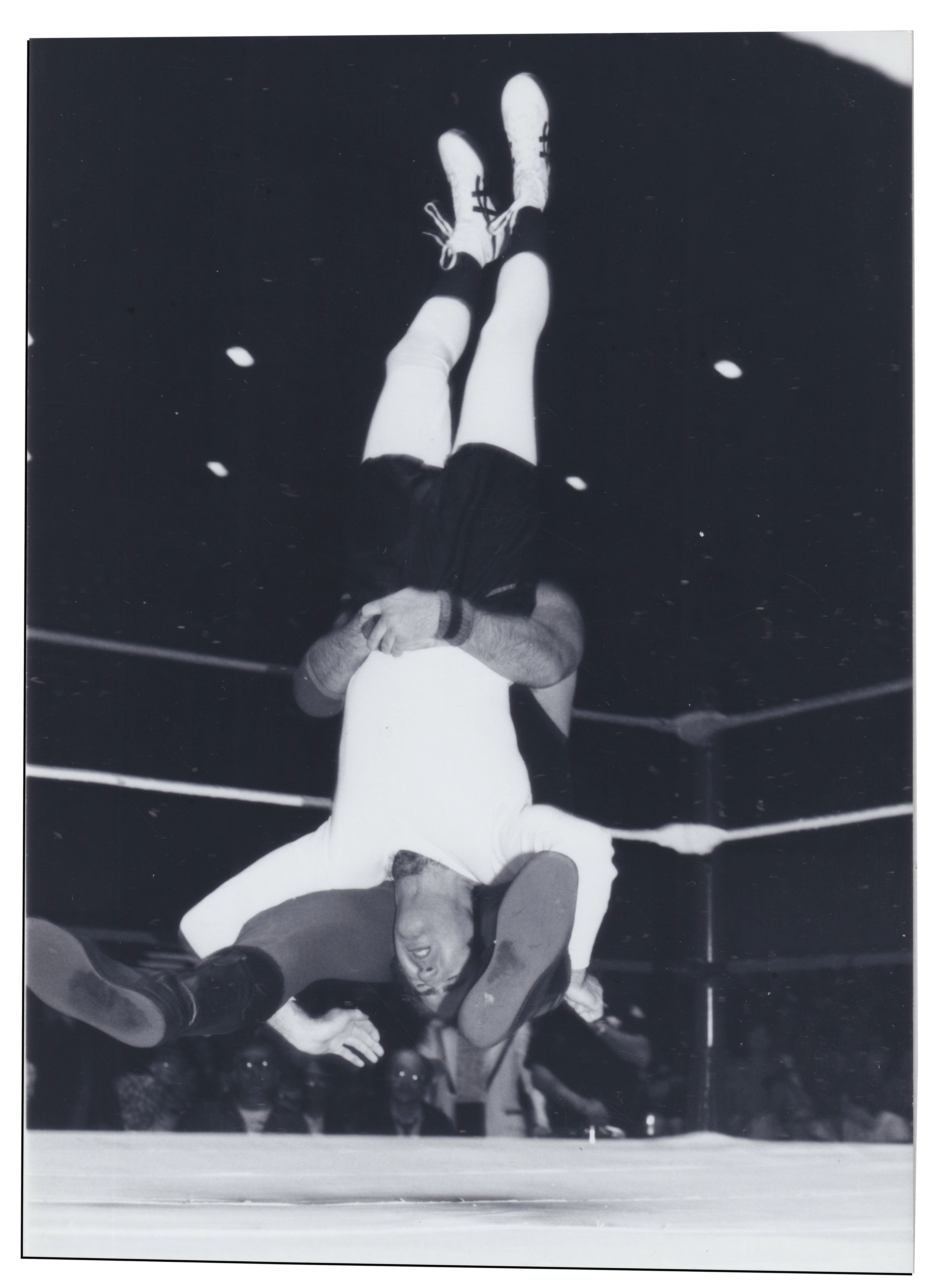 Lawler finishing Kaufman with dreaded pile driver move in black and white film photo