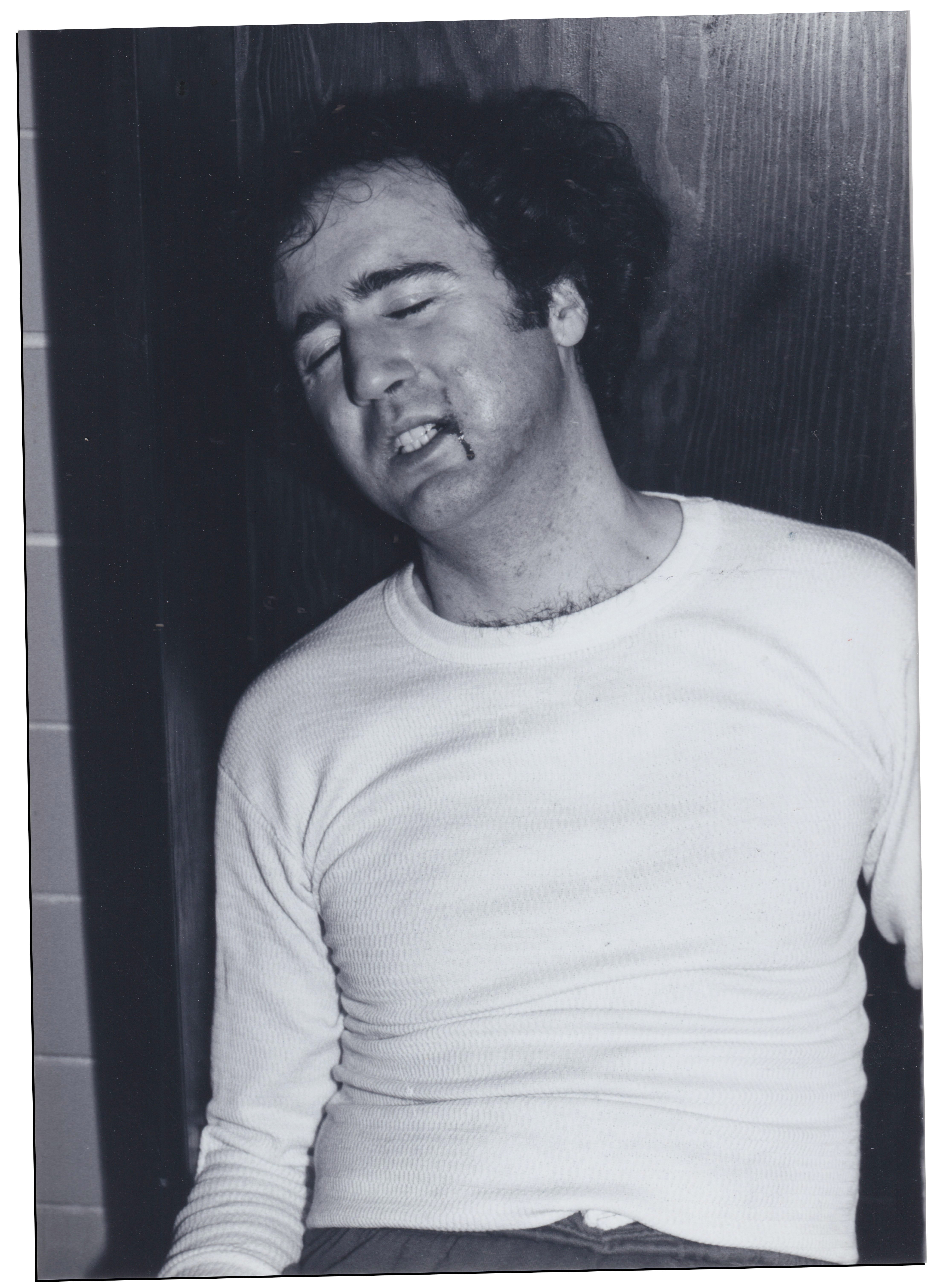 Kaufman with blood dripping from his mouth in black and white film photo