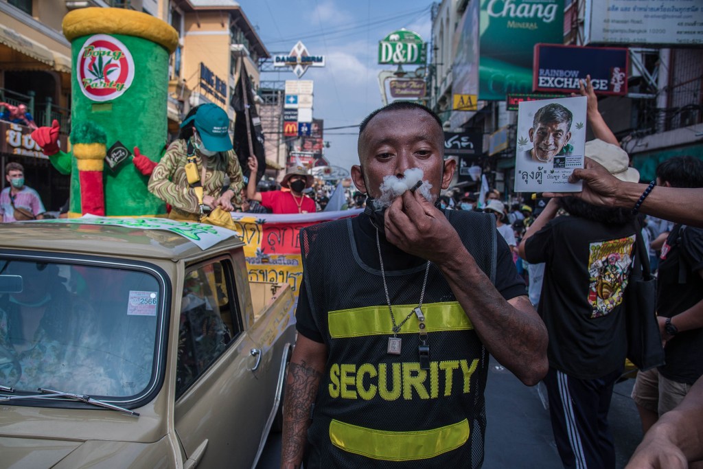 A man smokes a joint during the demonstration on Khao San road in Bangkok in April. ウィード