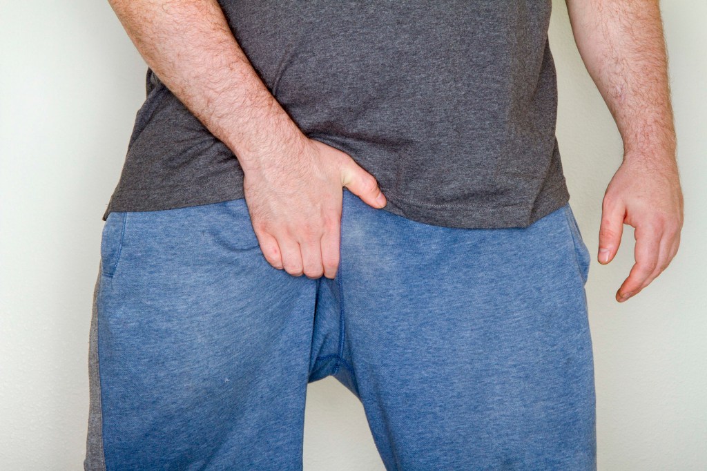 A man scratching his groin