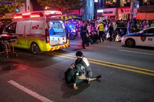 A woman comforting another after a Halloween crowd crush in the Itaewon neighborhood. Photo: Albert RETIEF / AFP