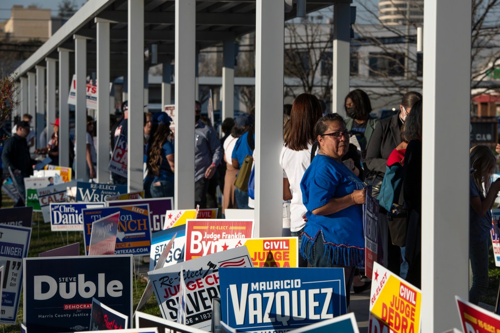 Voters wait in line outside of a polling place in Houston, Texas on March 1, 2022.