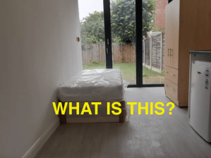 A wrapped up bed in a kitchen with doors leading into a garden