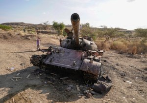 Tanks destroyed during combat sit by the side of the road on December 30, 2021