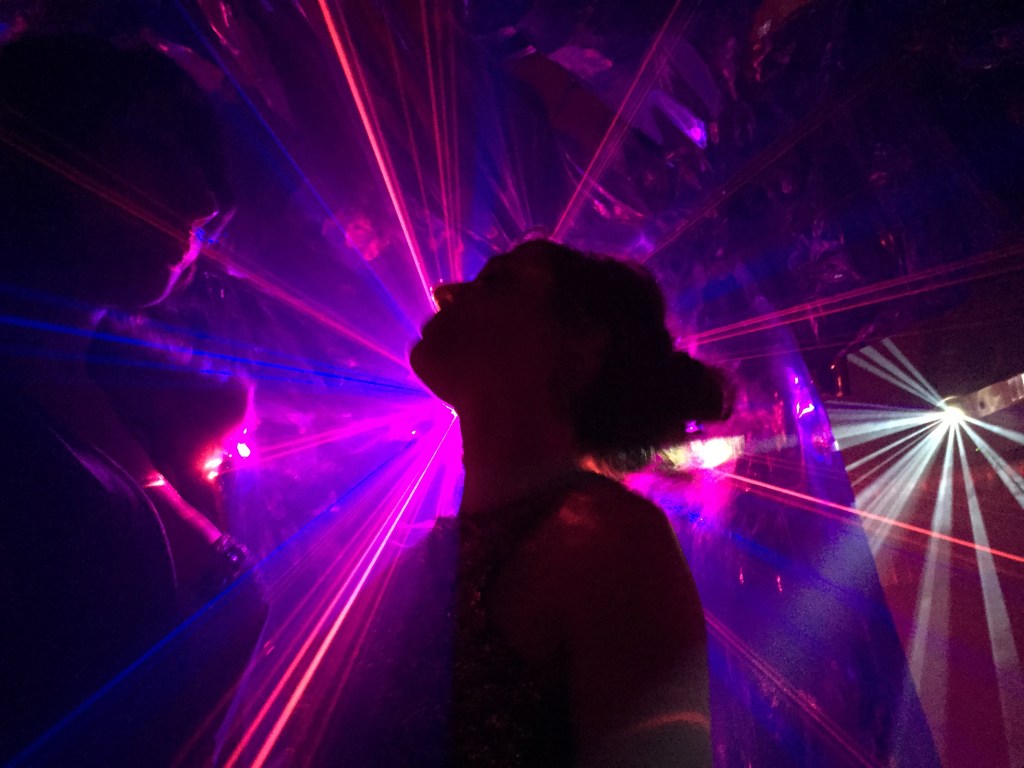 Woman dancing in club in front of lasers