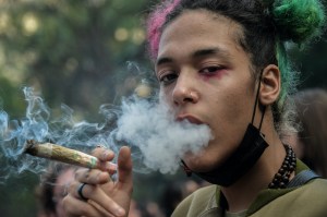 A demonstrator smokes a joint during a demonstration demanding the legalization of marijuana in Brazil, on June 11, 2022.