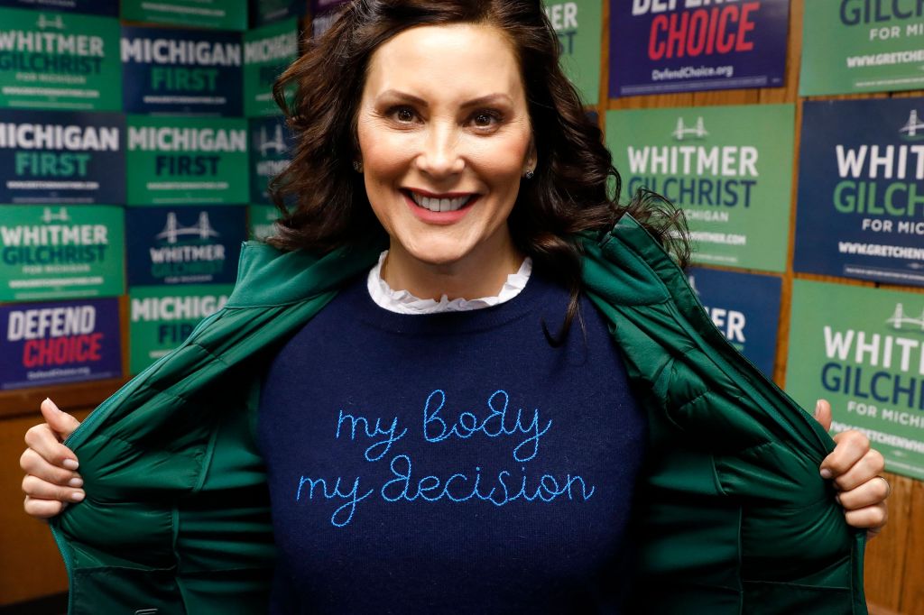 Michigan State Governor Gretchen Whitmer shows a "My Body My Decision" shirt at the 14th District Democratic Headquarters, during the US midterm election in Detroit, Michigan, on November 8, 2022.