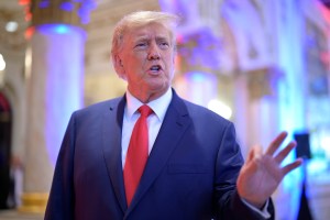 Former President Donald Trump answers questions from reporters during an election night party at Mar-a-Lago, Tuesday, November 8, 2022 in Palm Beach, Florida.