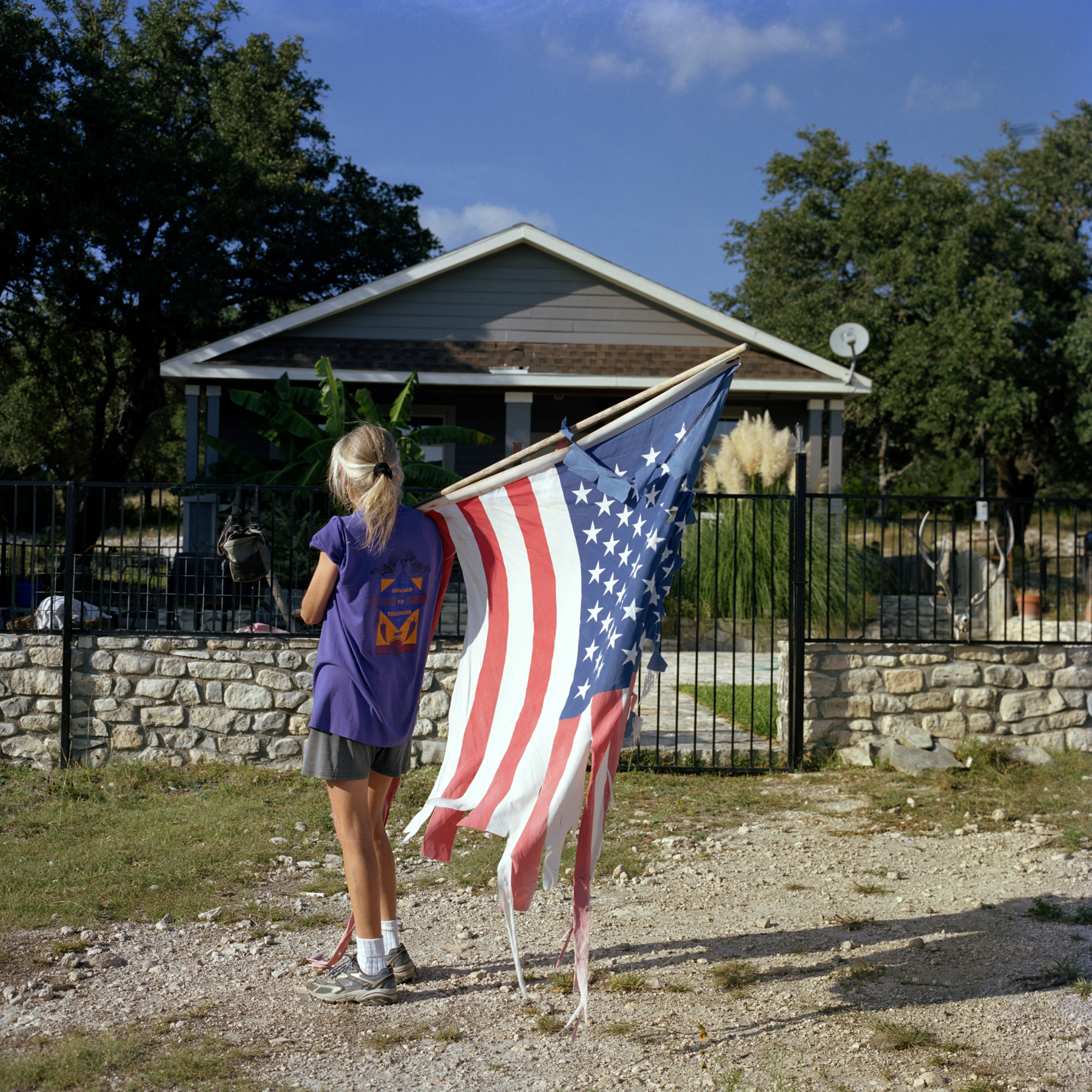 A ripped United States flag photographed in Texas in the mid-2000s.