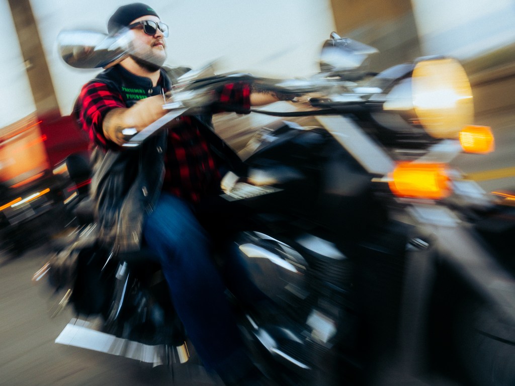 A blurry photo of a person riding a motorcycle