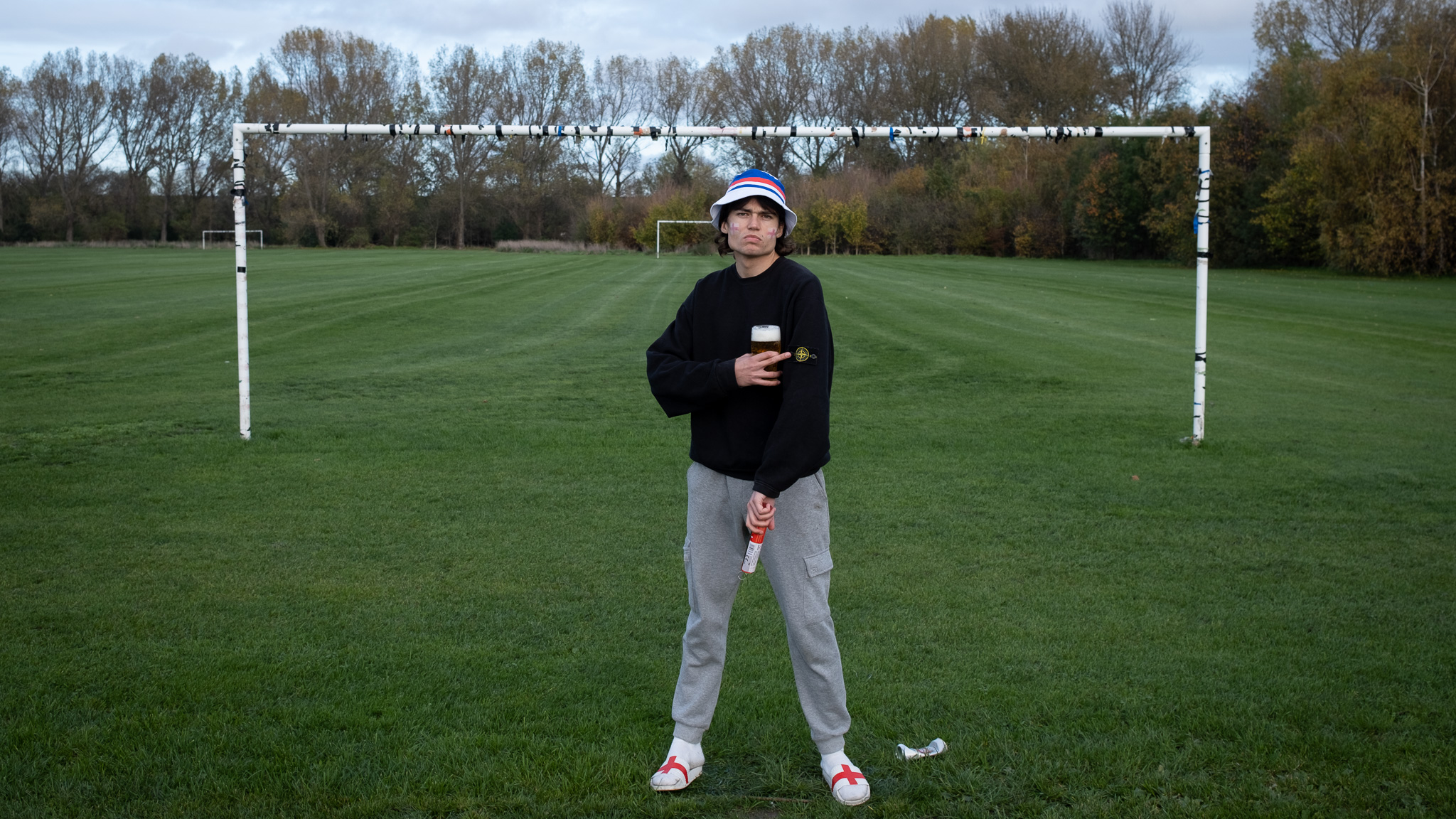 Man dressed as a football hooligan with Stone Island jumper and flare