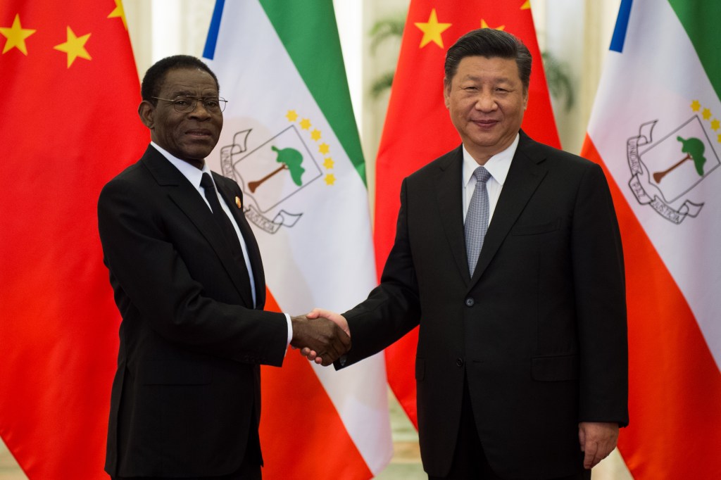 Equatorial Guinea's Teodoro Obiang Nguema Mbasogo shakes hands with China's President Xi Jinping.