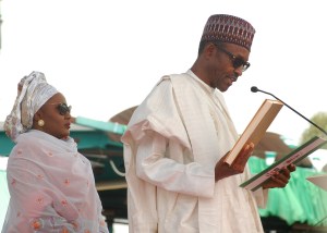 Muhammadu Buhari takes his oath of office with his wife Aisha Buhari.