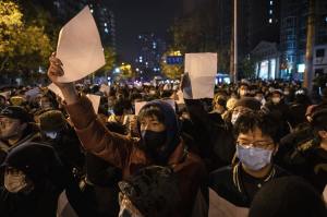 PROTESTERS TOOK TO THE STREETS IN BEIJING AND HELD UP BLANK PAPERS. PHOTO: ​KEVIN FRAYER/GETTY IMAGES