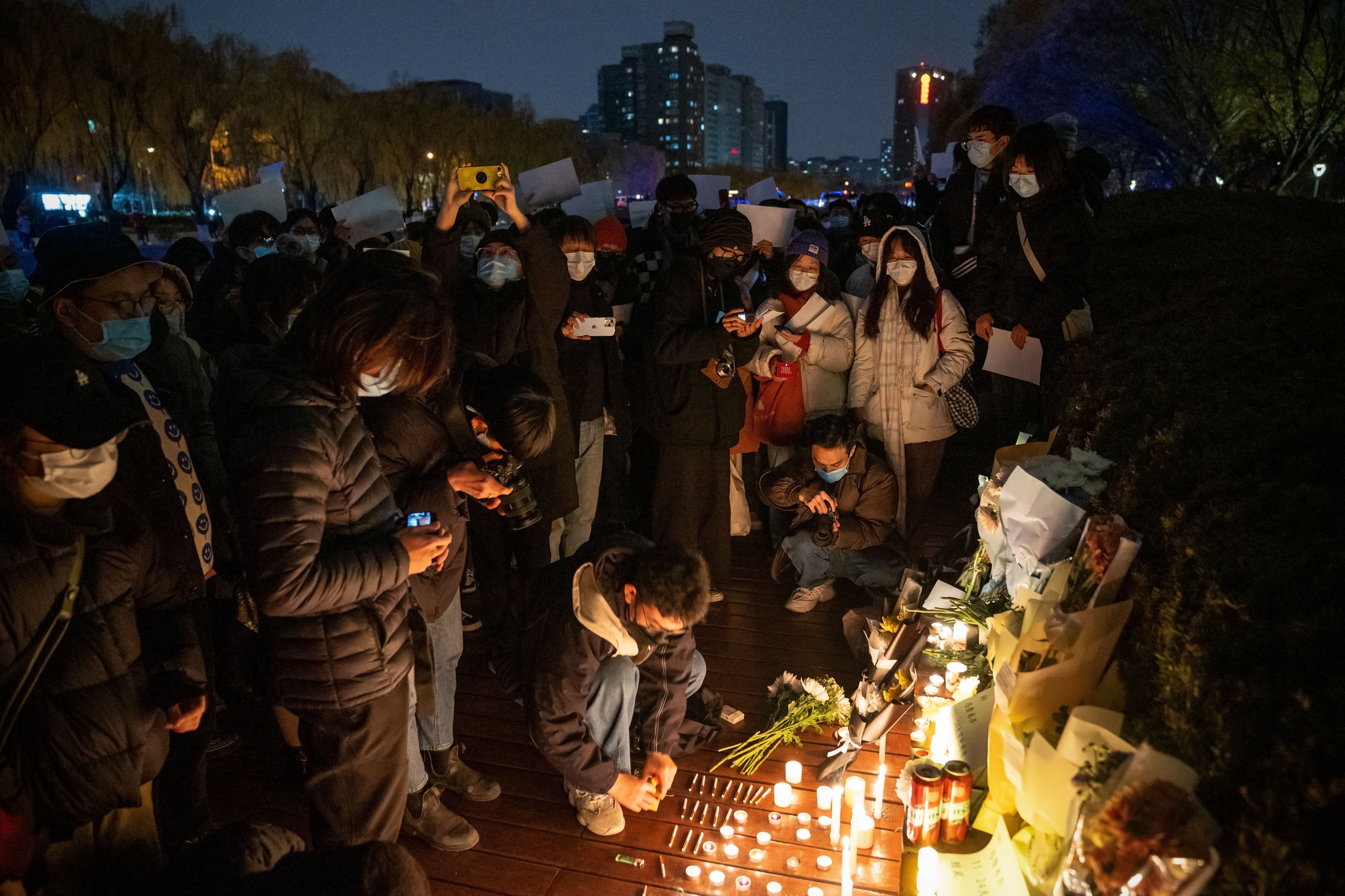 HUNDREDS JOINED A VIGIL IN BEIJING FOR VICTIMS OF THE URUMQI FIRE. PHOTO: KEVIN FRAYER/GETTY IMAGES