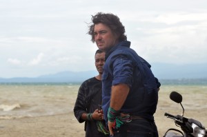 Australian animal handling expert, Matthew Wright (right) stands around the river after closing the rescue mission of a crocodile caught in a motorcycle tire