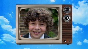 Actor Daniel Roche as his Outnumbered character on a old tv set floating in the sky.