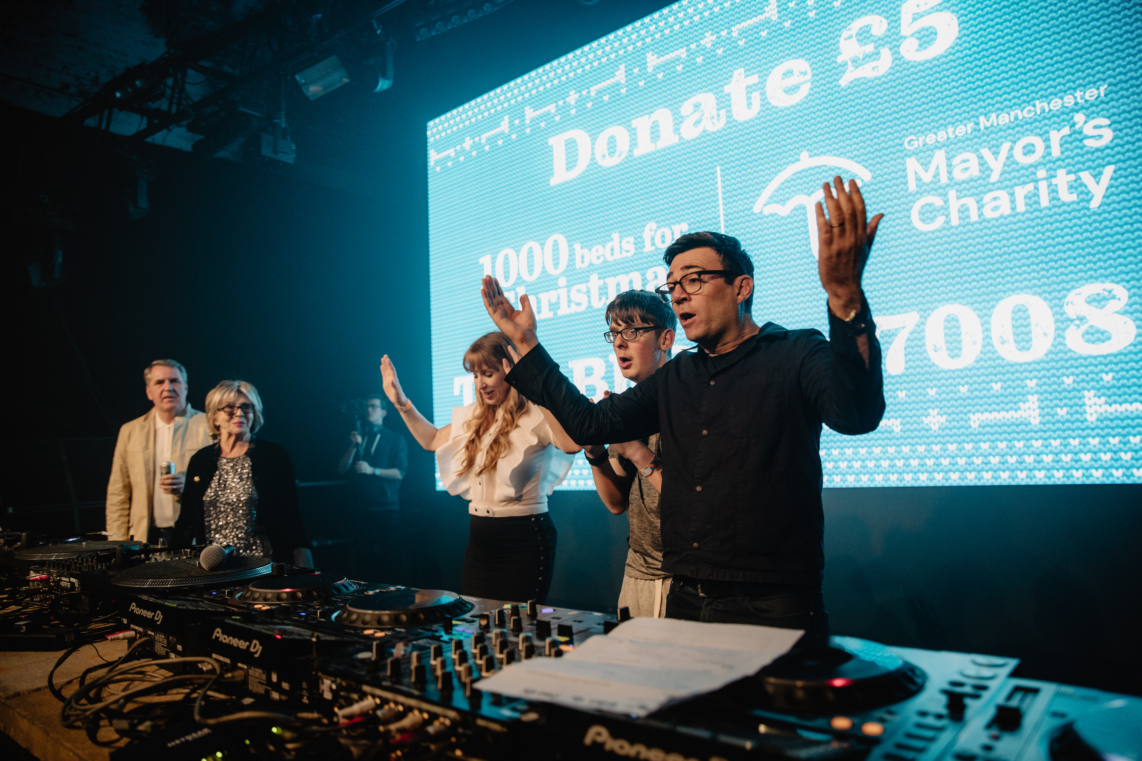 Mayor Andy Burnham behind the DJ decks dancing with Angela Raynor and other Labour party officials.