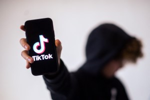 A teenager holds a smartphone with the TikTok logo on January 21, 2021 in Nantes, France.