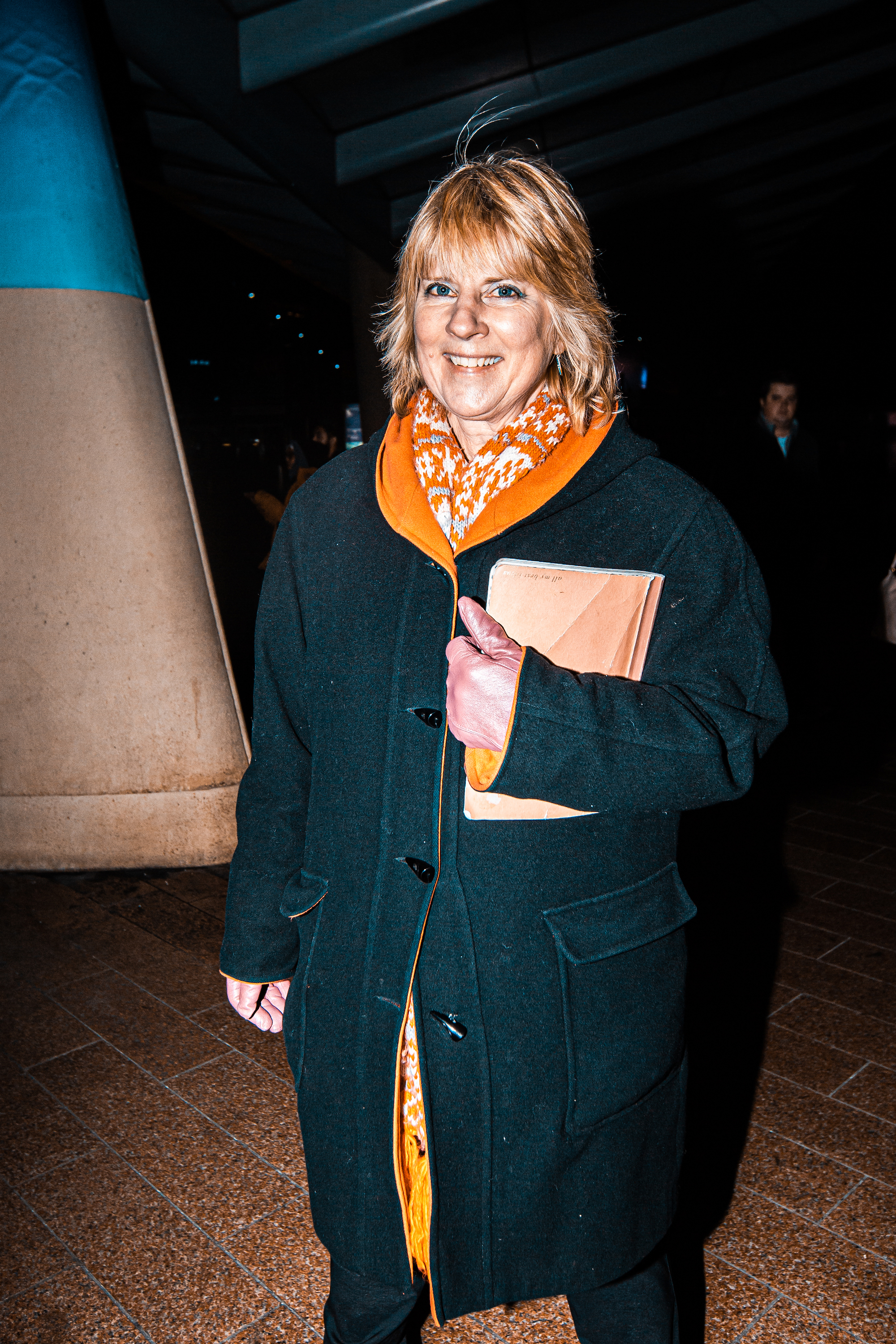 A Peter Kay fan outside his London O2 gig in an orange scarf and black coat