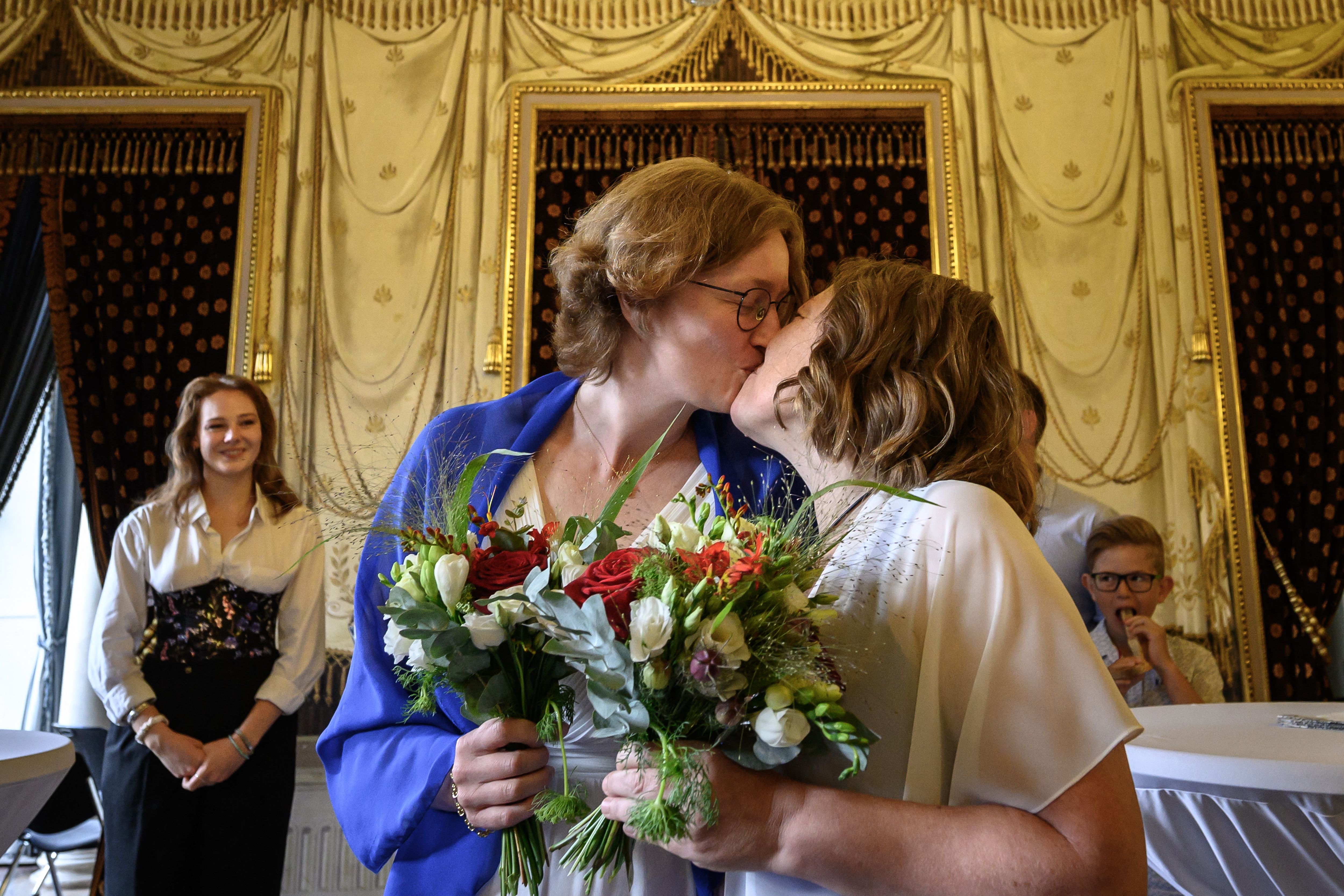 Laure (left) and Aline kiss each other after their wedding ceremony in Geneva after the marriage for all Swiss law entered into force as of the 1st of July. Photo: FABRICE COFFRINI/AFP via Getty Images