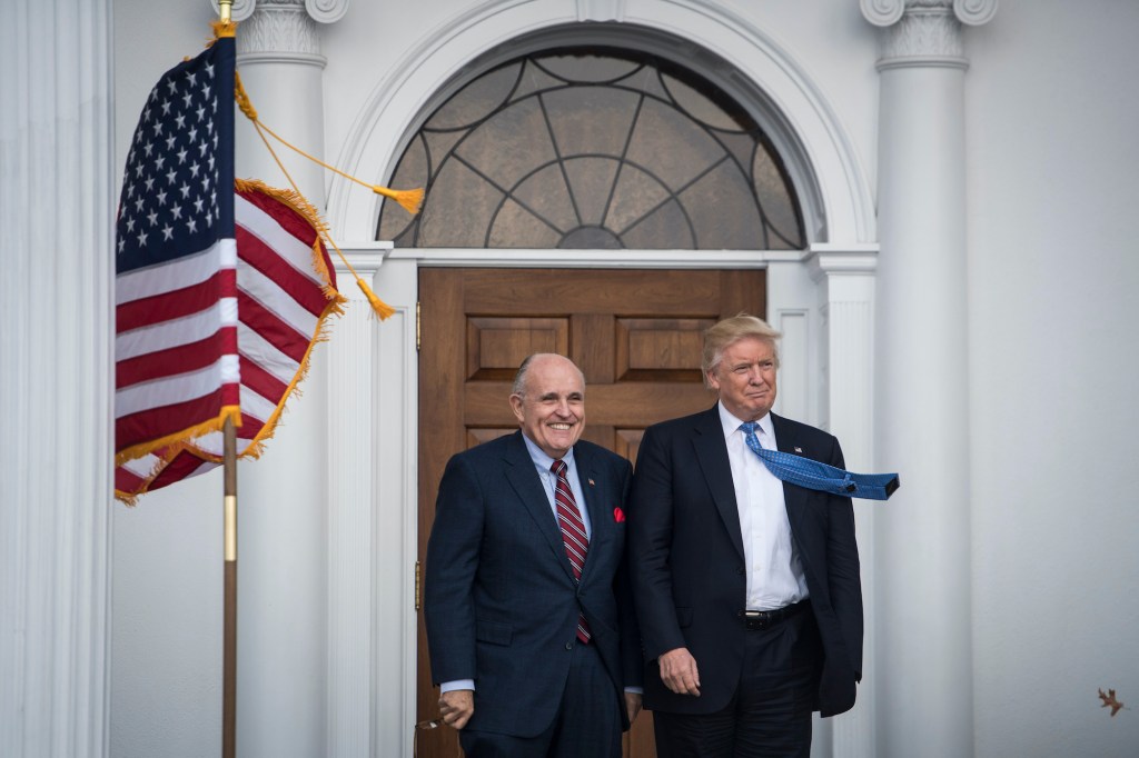 President-elect Donald Trump greets Rudy Giuliani at the clubhouse at Trump National Golf Club Bedminster in Bedminster Township, N.J. on Sunday, Nov. 20, 2016.