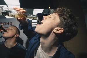 Man pouring a Corona beer into his mouth