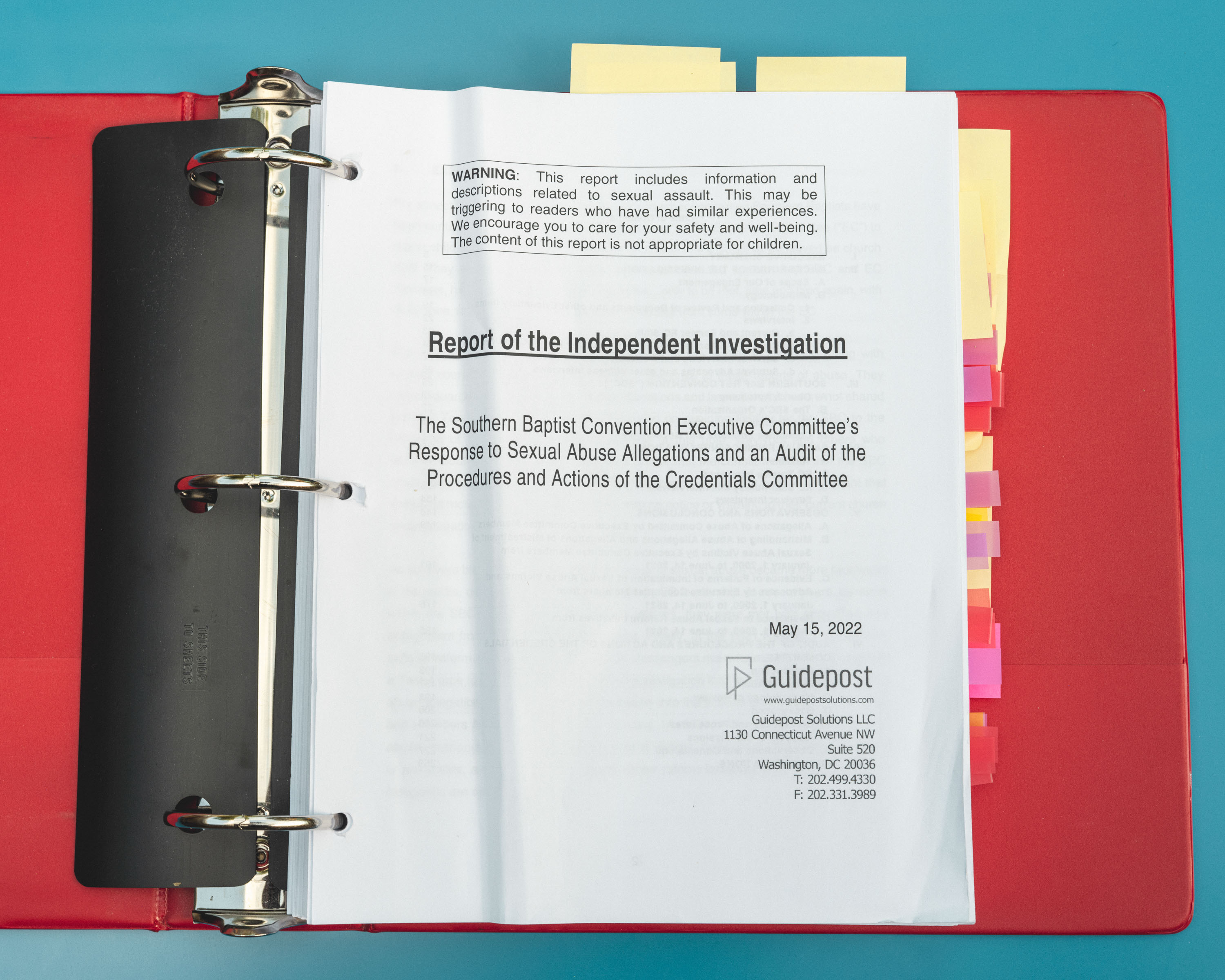 A binder containing the independent investigation and Christa's post-it markers.